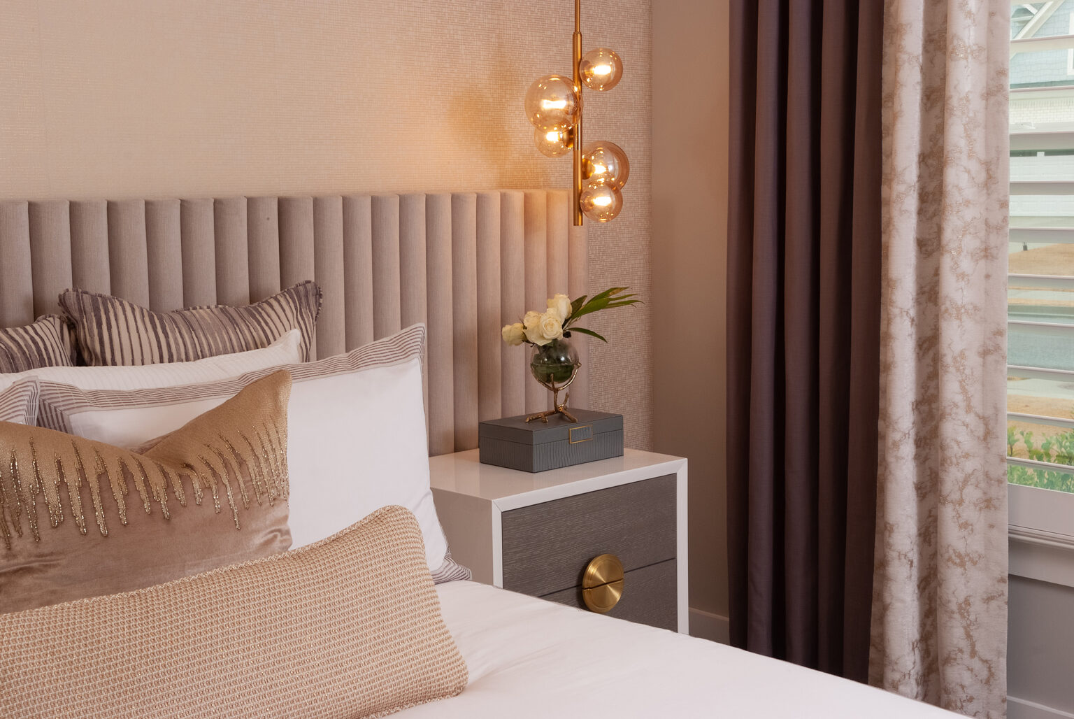 Neutral bedroom with gold pendant lighting